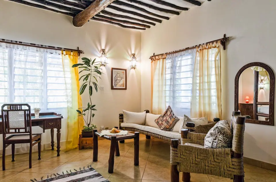 Sunlit sitting room with carved wooden furniture