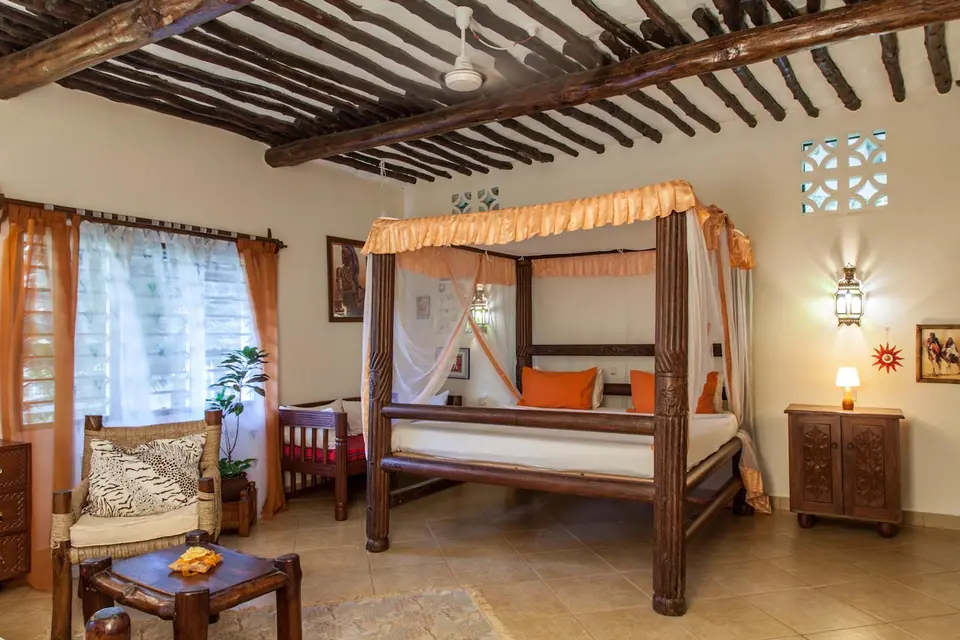 Spacious bedroom with hand-carved four-poster bed