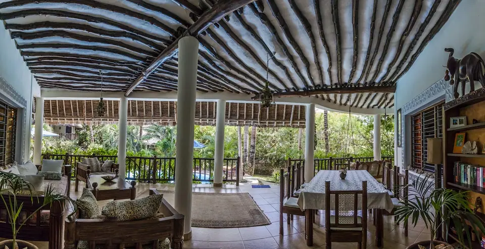 Veranda dining and lounge under a mangrove-pole ceiling